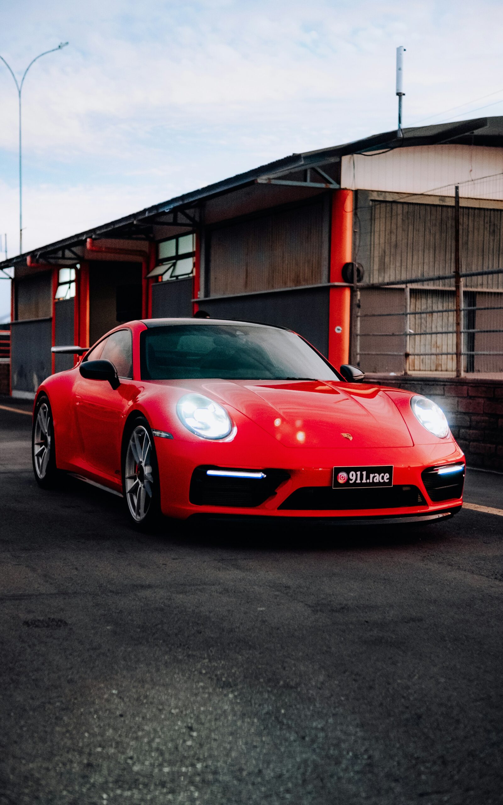 A red sports car parked in front of a building